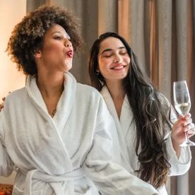 Friends celebrate the spa way with champagne and thick terry cloth robes.
