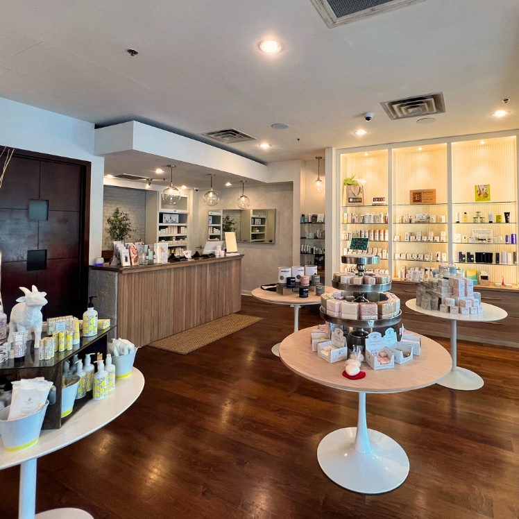 Buckhead's lobby has round display tables and well-lit shelves full of skincare products at Natural Body in Atlanta