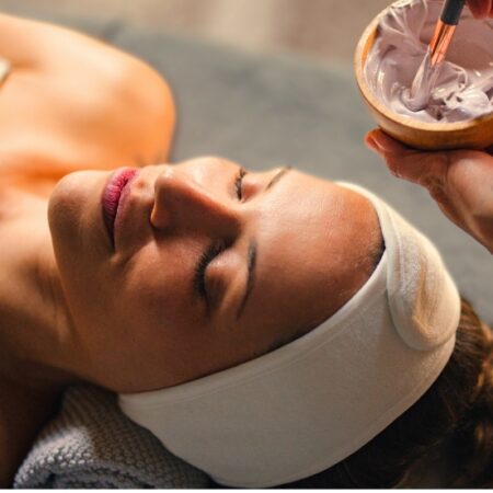Woman about to receive a facial and mask laying down at Natural Body Spa + Med Spa in Atlanta, GA