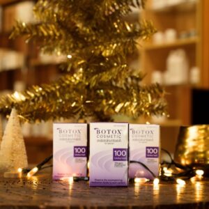 Three Botox vial boxes staged in front of holiday decor at Natural Body Spa + Med Spa in Atlanta, GA